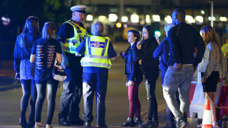Police and fans outside the Manchester Arena on Monday, following reports of an explosion after Ariana Grande had performed.