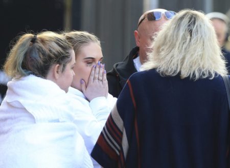 Fan leaves the Park Inn hotel in central Manchester, England, Tuesday, May 23, 2017. Over a dozen people were killed in an explosion following a Ariana Grande concert at the Manchester Arena late Monday evening. (AP Photo/Rui Viera)
