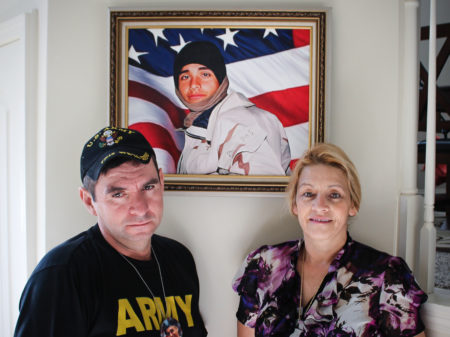 George Rincon and Yolanda Reyes stand with a portrait of their son Diego Rincon. The family immigrated to the U.S. from Colombia in 1989. Diego served in the Army and was killed in Iraq in 2003.