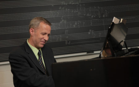 Composer Mark Kilstofte at piano