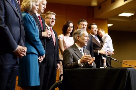Gov. Greg Abbott signs four bills aimed at reforming Child Protective Services, at the Texas Department of Family and Protective Services headquarters in Austin on May 31, 2017.