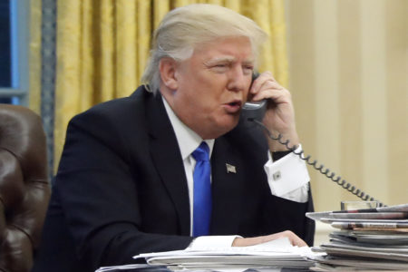 FILE - In this Jan. 28, 2017, file photo, President Donald Trump speaks on the phone with Prime Minister of Australia Malcolm Turnbull in the Oval Office of the White House in Washington. Trump, who blasted Hillary Clinton for using a personal email server, might be a walking magnet for eavesdropping and malware if he is using an unsecured cellphone to chat with foreign leaders. Trump has been handing out his cellphone number to counterparts around the world, urging them to call him directly to avoid the red tape of diplomatic communications. The practice has raised concern about the security and secrecy of the U.S. commander-in-chief's communications. (AP Photo/Alex Brandon, File)
