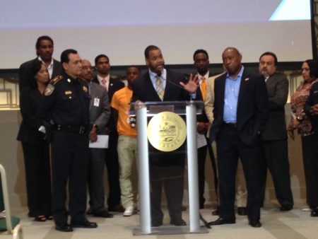 Karlton Harris (center), who works for the City’s Health Department –which manages My Brother’s Keeper in Houston— speaks about the new programs during a press conference held at City Hall.