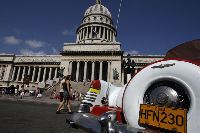 An American classic car is seen parked in front of the Capitol building in Havana. President Trump's expected changes in policy toward Cuba could make it more difficult for Americans to visit the island and for U.S. companies to do business there. Javier Galeano/AP
