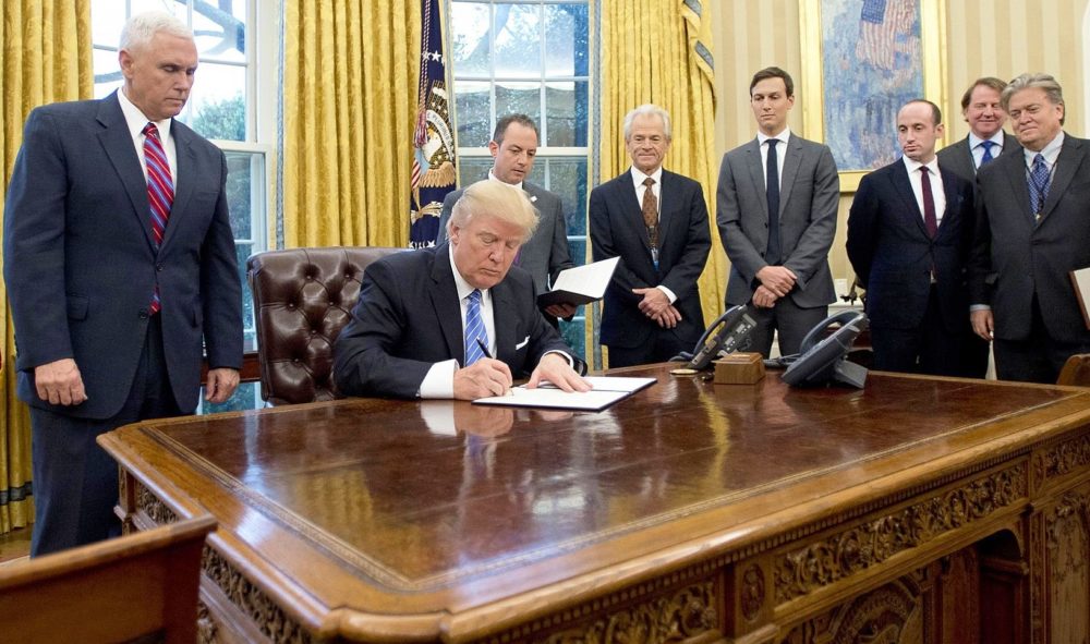 President Trump signing the Presidential memoranda regarding the Federal hiring freeze, the Mexico City Policy, and the TPP withdrawal on January 23, 2017.