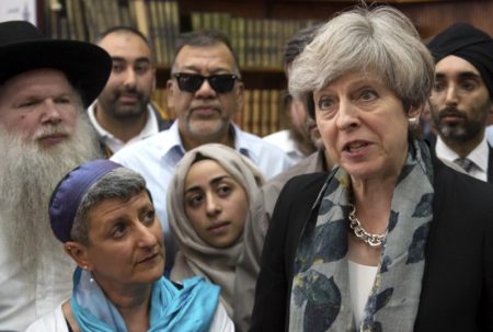Britain’s Prime Minister Theresa May, right, talk to faith leaders at Finsbury Park Mosque in north London, after an incident where where a van struck pedestrians, in London, Monday June 19, 2017. British authorities and Islamic leaders moved swiftly to ease concerns in the Muslim community after a man plowed his vehicle into a crowd of worshippers outside a north London mosque early Monday, injuring at least nine people.﻿﻿ (Stefan Rousseau/Pool Photo via AP)