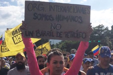 At a protest in Venezuela, this woman's sign reads "We are human not a barrel of oil "
