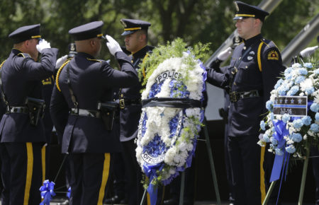 Dallas Police officers salute during a memorial service for fallen peace officers in downtown Dallas, Wednesday, May 17, 2017. The Dallas Police Department and city leaders held a ceremony to honor fallen officers as part of the annual Police Memorial Day less than a year after five officers were slain. (AP Photo/LM Otero)
