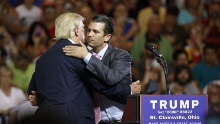Donald Trump Jr. hugs his father, Donald Trump, during a campaign rally in Ohio, weeks after Trump Jr. met with a Russian lawyer, as he sought dirt against Democrat Hillary Clinton.