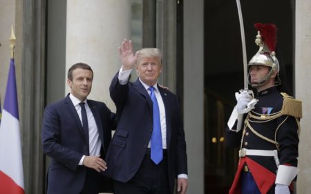 French President Emmanuel Macron, left, welcomes a waving U.S President Donald Trump before their meeting at the Elysee Palace in Paris, Thursday, July 13, 2017