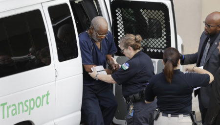 James Mathew Bradley Jr., 60, of Clearwater, Fla., left, arrives at the federal courthouse for a hearing, Monday, July 24, 2017, in San Antonio. Bradley was taken into custody and is expected to be charged in connection to the people who died after being crammed into a sweltering tractor-trailer found parked outside a Walmart in the midsummer Texas heat Sunday, according to authorities in what they described as an immigrant-smuggling attempt gone wrong. (AP Photo/Eric Gay)