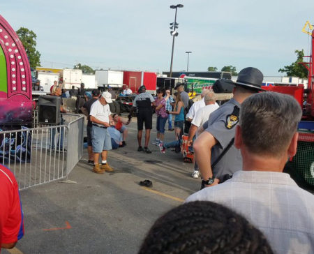 A person is attended to as authorities respond after the Fire Ball amusement ride malfunctioned injuring several at the Ohio State Fair, Wednesday, July 26, 2017, in Columbus, Ohio. Columbus Fire Battalion Chief Steve Martin said that some of the victims were thrown from the ride when it malfunctioned Wednesday night. (Justin Eckard via AP)