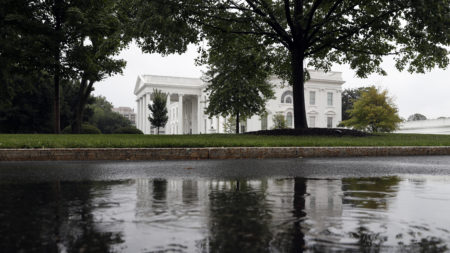 The White House is seen reflected in a rainwater puddle on Friday, July 28, 2017 -- amid very stormy times in Washington, D.C.
