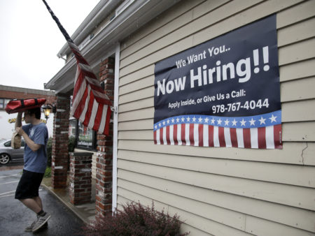 A sign advertising job openings hangs outside a restaurant in Middleton, Mass., last month. At 4.3 percent unemployment, the jobs rate is near the point that most economists deem full employmen