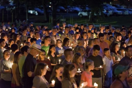 Hundreds from Hallsville, Texas, and surrounding communities gather for a candlelight vigil Sunday, August 6, 2017, after two Hallsville Boy Scouts were killed and another severely injured in a Saturday boating accident.