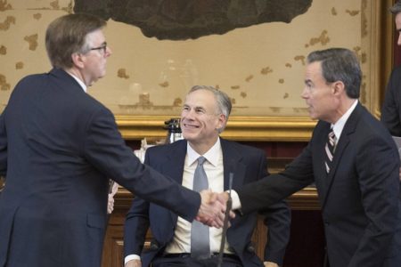 Gov. Greg Abbott looks on as Lt. Gov. Dan Patrick (left) and House Speaker Joe Straus shake hands at the Capitol on May 27, 2017.