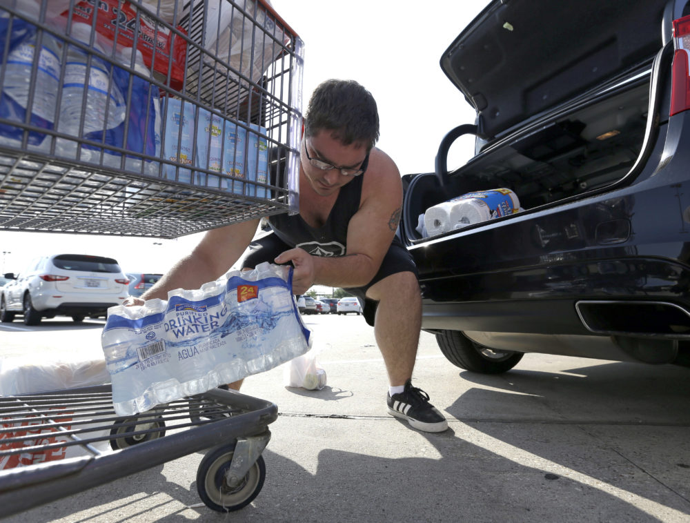 William Hazzard loads water into his car in preparation for tropical weather on Thursday, Aug. 24, 2017, in Houston. Tropical Storm Harvey is expected to intensify over the warm waters of the Gulf of Mexico before reaching the Texas coast Friday. (