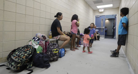 Stephanie Garcia, left, waits with her family at a high school gym to be evacuated as the outer bands of Hurricane Harvey begin to make landfall, Friday, Aug. 25, 2017, in Corpus Christi, Texas. Harvey intensified into a hurricane Thursday and steered for the Texas coast with the potential for up to 3 feet of rain, 125 mph winds and 12-foot storm surges in what could be the fiercest hurricane to hit the United States in almost a dozen years.(AP Photo/Eric Gay)