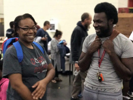 Demetrius Washington and his mother, Ramona, learn that his grandmother is safe Tuesday, Aug. 29 at the George R. Brown Convention Center in Houston.
