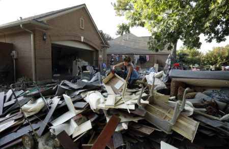 Liv Gilreath searches for salvageable items from a friend's home after floodwaters from Hurricane Harvey drenched the city, Thursday, Aug. 31, 2017, in Houston. (AP Photo/Gregory Bull)