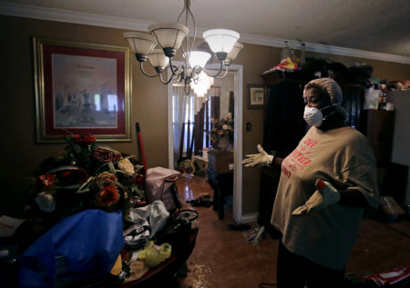 Lois Rose looks over belongings while salvaging items from her flood-damaged house Thursday, Aug. 31, 2017, in Houston. The city continues to recover from record flooding caused by Hurricane Harvey.