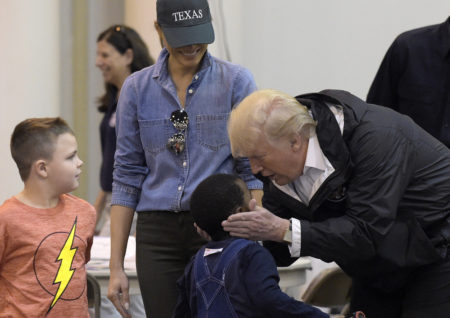 President Donald Trump and Melania Trump meet people impacted by Hurricane Harvey during a visit to the NRG Center in Houston, Saturday, Sept. 2, 2017. Trump cupped a boy's face in his hands and then gave him a high-five. It was his second trip to Texas in a week, and this time his first order of business was to meet with those affected by the record-setting rainfall and flooding. He's also set to survey some of the damage and head to Lake Charles, Louisiana, another hard-hit area.