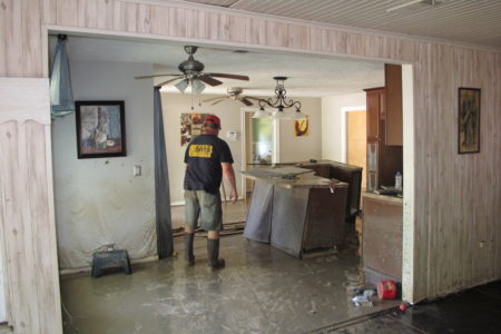 Dwight Chandler walks through his devastated home in Highlands, Texas on Thursday, Aug. 31, 2017. Chandler, 62, said he worried whether Harvey's floodwaters had also washed in pollution from the old acid pits that were designated as a U.S. EPA Superfund site just a couple blocks from his home. The Highlands Acid Pit site near Chandler's home was filled in the 1950s with toxic sludge and sulfuric acid from oil and gas operations. (AP Photo/Jason Dearen)