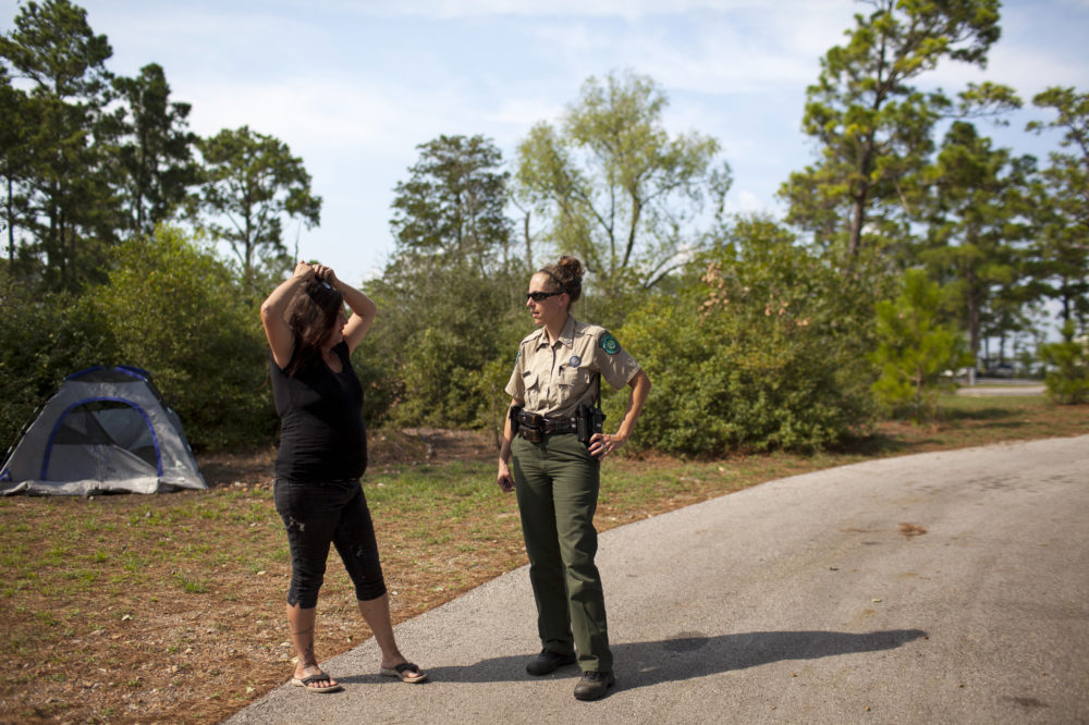 Susan Arawley (left) speaks with Jamie Creacy, superintendent of the Lost Pines Complex, which includes Bastrop State Park. As Hurricane Harvey hit, Arawley tried picking up supplies and got stuck in rising flood water. After sleeping in her car four nights, she decided to head to Bastrop State Park, where she could take a shower.