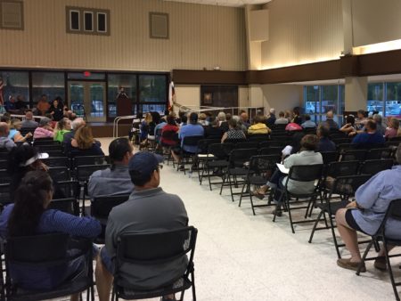 Residents of League City attend a town hall meeting to learn more about Harvey recovery programs.