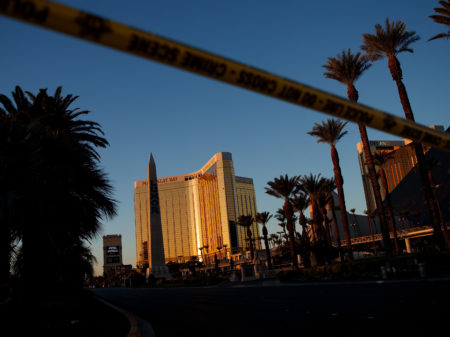 Police tape blocks off part of Las Vegas Blvd. on Tuesday near the scene of a massacre at a country music festival in Las Vegas. Twelve devices known as bump stocks were found in the gunman's room.