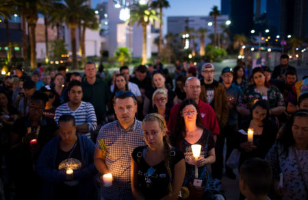 Mourners attend a candlelight vigil at the corner of Sahara Avenue and Las Vegas Boulevard for the victims of Sunday night's mass shooting in Las Vegas, Nevada.