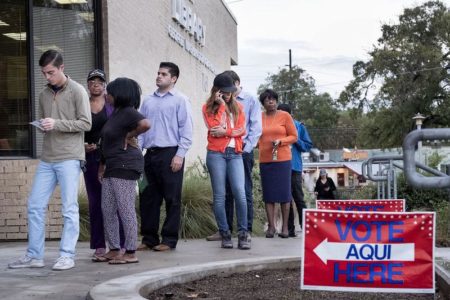 People wait in line at the George Washington Carver Library in Austin, Texas, to cast their vote on Election Day 2016.