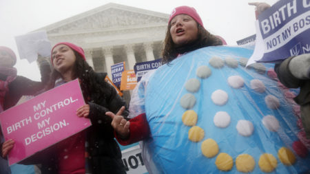Demonstrators in Washington, D.C., argued for  upholding the Affordable Care Act's birth control provision in 2015. The rollback of the rule is likely to spur further lawsuits, analysts say