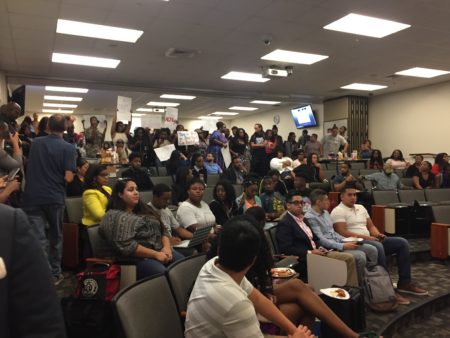 Students at Texas Southern University stand in protest of Texas State Representative Briscoe Cain speaking on campus.