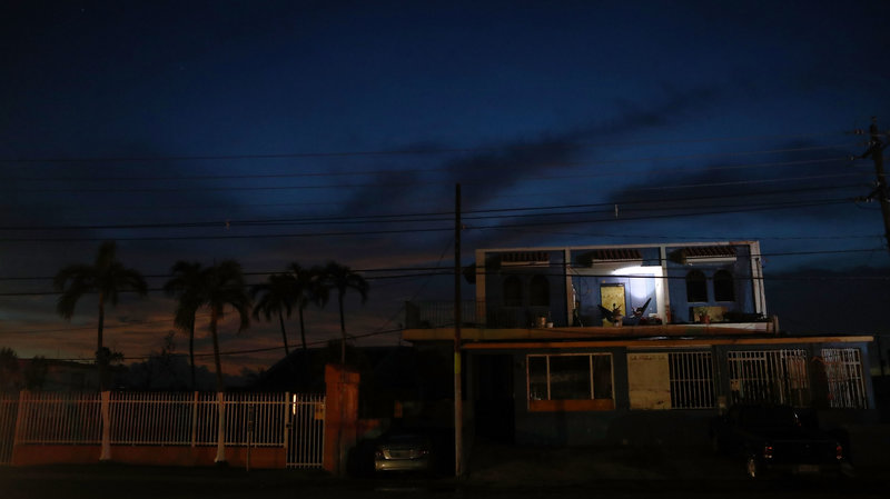 A man rests in a hammock, using a battery-operated light, in an area without electricity more than two weeks after Hurricane Maria hit the island in San Isidro, Puerto Rico.
