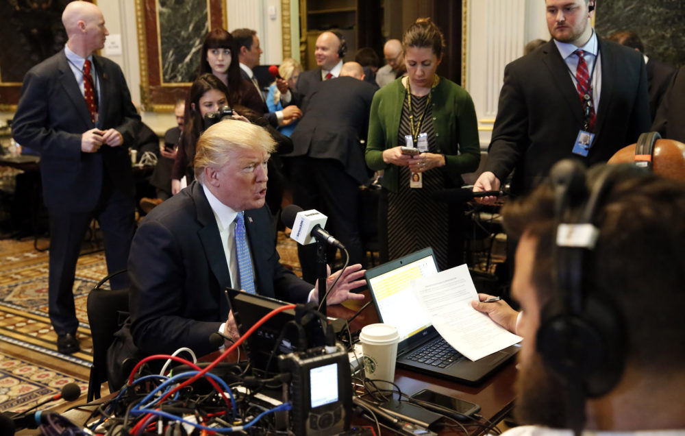 President Trump participates in a series of radio interviews in the Indian Treaty Room of the Eisenhower Executive Office Building on Tuesday. Among the topics he discussed was his and past presidents' policies on reaching out to families of service members who have die