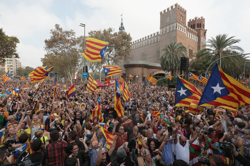 Catalan independence supporters react to the news that the regional parliament voted to declare independence from Spain, Friday in Barcelona.
