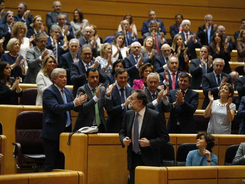 Spanish Prime Minister Mariano Rajoy (center) is applauded after a speech in Madrid on Friday in which he appealed to the country's Senate to grant special authority to dissolve Catalonia's regional government.
