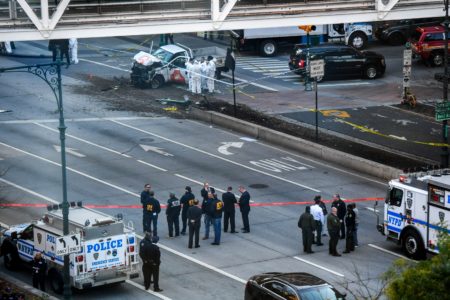 Investigators inspect a truck following a shooting incident in New York on Tuesday. Eight people were killed and at least 11 others injured in New York on Tuesday when a suspect plowed a vehicle into a bike and pedestrian path in Lower Manhattan, and struck another vehicle. A suspect exited the vehicle holding up fake guns, before being shot by police and taken into custody, officers said