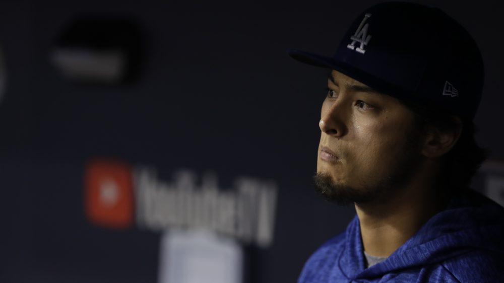 Los Angeles Dodgers starting pitcher Yu Darvish watches from the dugout during the eighth inning after being pulled for a reliever early in the game.