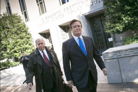 Former Trump campaign chairman Paul Manafort (right) leaves federal court after pleading not guilty following his indictment on federal charges Monday.