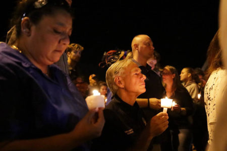 Texas Governor Greg Abbott attends a candlelight vigil on Sunday, November 5, 2017 after a gunman killed 26 people at a church in Sutherland Springs, TX.