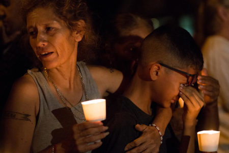 Mona Rodriguez holds her son J. Anthony Hernandez during a candlelight vigil held on Sunday night for the 26 people killed in a shooting at the First Baptist Church in Sutherland Springs.