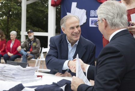 Gov. Greg Abbott and Republican Party of Texas Chairman James Dickey shake hands after Abbott formally filed his papers for re-election, on Saturday, Nov. 11, 2017 in Austin.