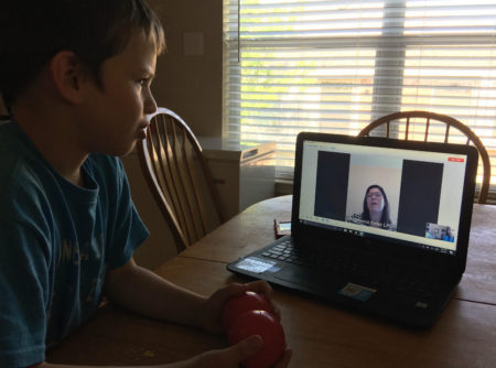 Josh Masters listens to Children's Health licensed counselor Angeleena May using the hospital's telehealth connection. Children's Health now has more than 100 telehealth school partners.