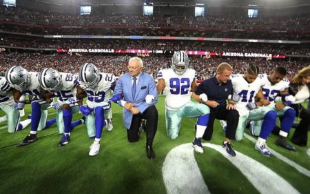 Jerry Jones and the Cowboys take a knee before their game against the Arizona Cardinals.