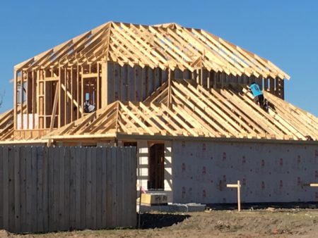 A construction crew works on a home being built in a new subdivision located in the greater Houston area on December 9, 2017.