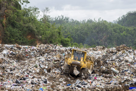 The active part of the landfill in Toa Baja is currently a hot, rancid, open dump. Federal regulations require trash piles to be covered daily with earth. But the site's supervisor says that's currently impossibl