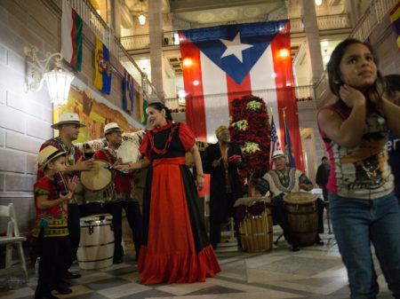 A musical group playing traditional Puerto Rican bomba music performs at a parranda in Hartford, Conn.