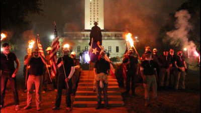 Austin, Texas, November 4, 2017: Approximately 25 Patriot Front members and associates, wearing masks and carrying burning torches, demonstrated in front of the George Washington statue at the University of Texas.